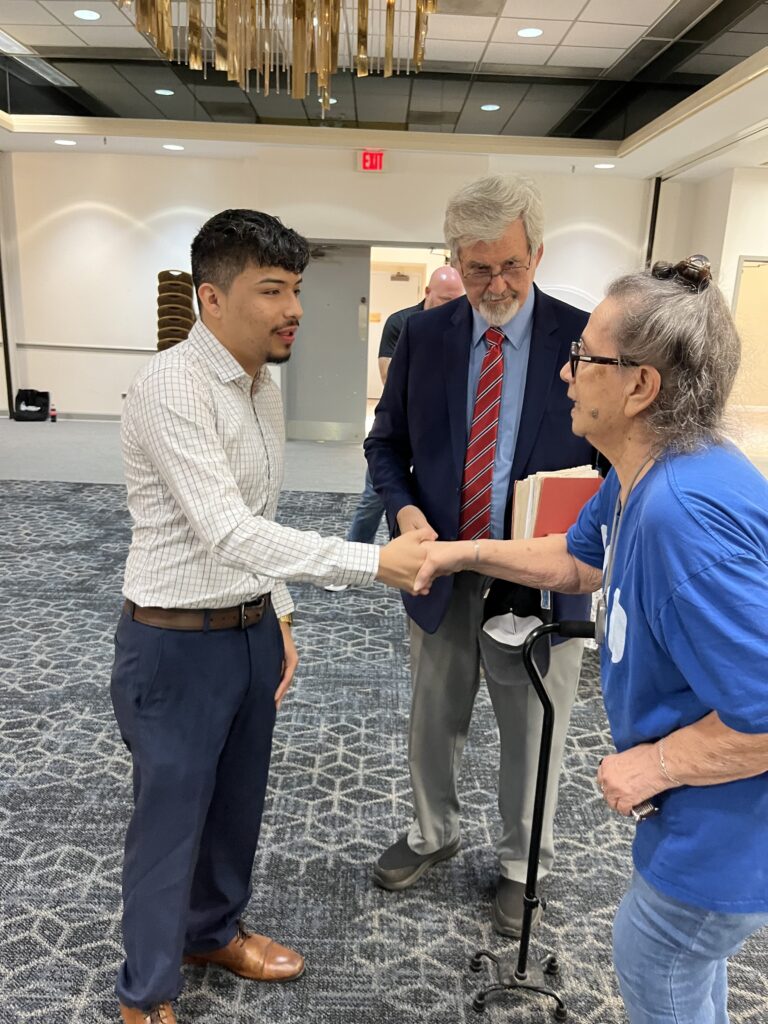 Adrian Maldonado greets a town hall guest