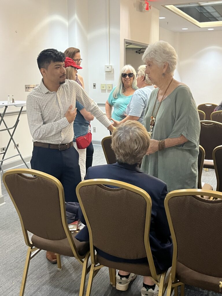 Adrian Maldonado speaks with a guest